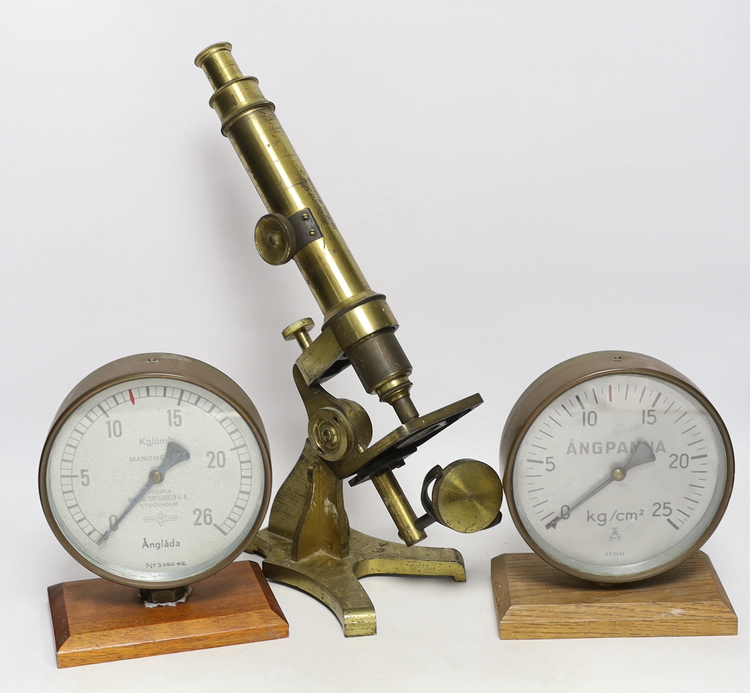 A Watson & Son brass microscope and two Swedish brass mounted gauges.